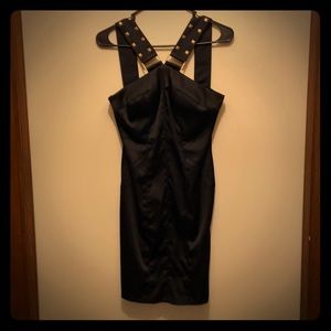 Black dress with gold strap detail.